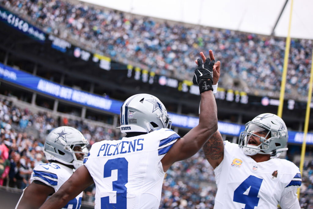 Oct 12, 2025; Charlotte, North Carolina, USA; Dallas Cowboys wide receiver George Pickens (3) celebrates with quarterback Dak Prescott (4) during the first half at Bank of America Stadium. Mandatory Credit: Scott Kinser-Imagn Images